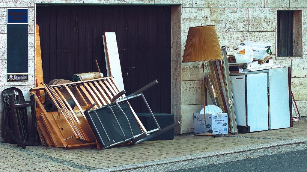 A garage with a lot of furniture in front of it.