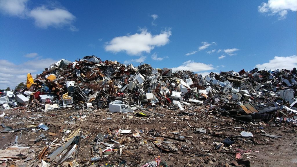 A pile of scrap metal in the middle of a field.
