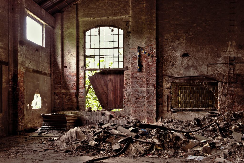 A room in an abandoned building with a broken window.