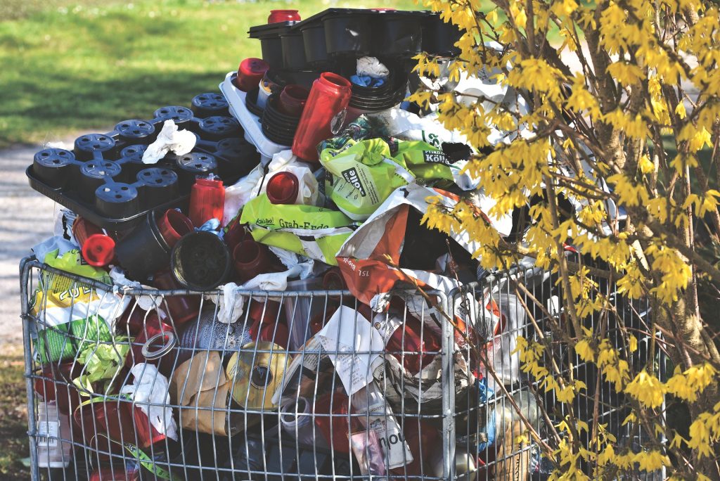 A trash can with a lot of items in it.