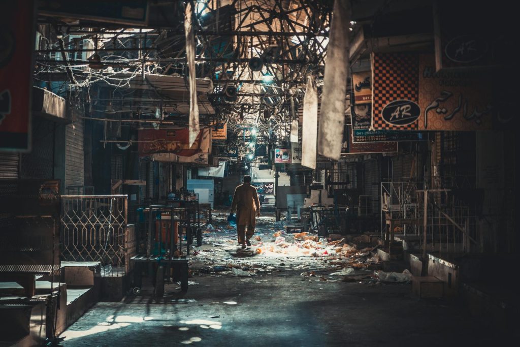 A man standing in a dark alley way