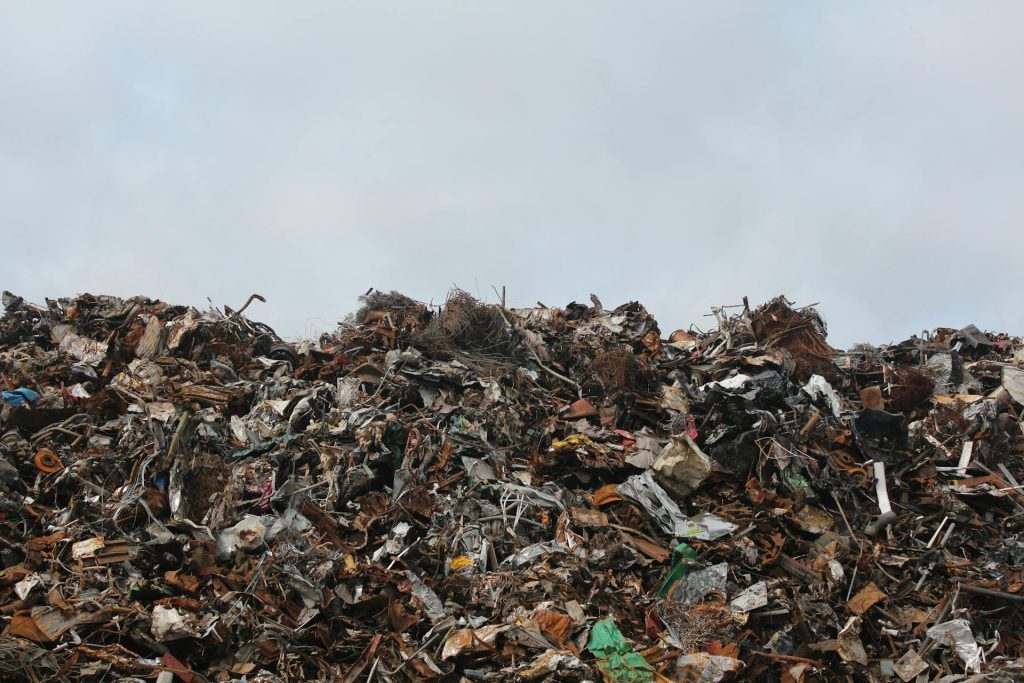 A large pile of garbage sitting on top of a field