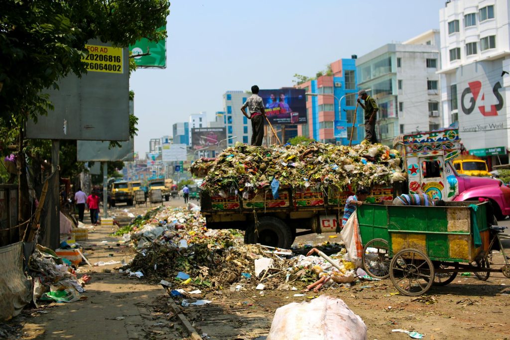 A street scene with a truck full of garbage