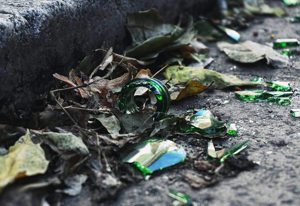 A pile of broken glass bottles sitting on the ground