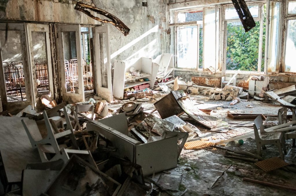 A room filled with lots of rubble and broken windows